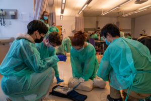 Physician assistant students learning CPR on a dummy at Northeastern University