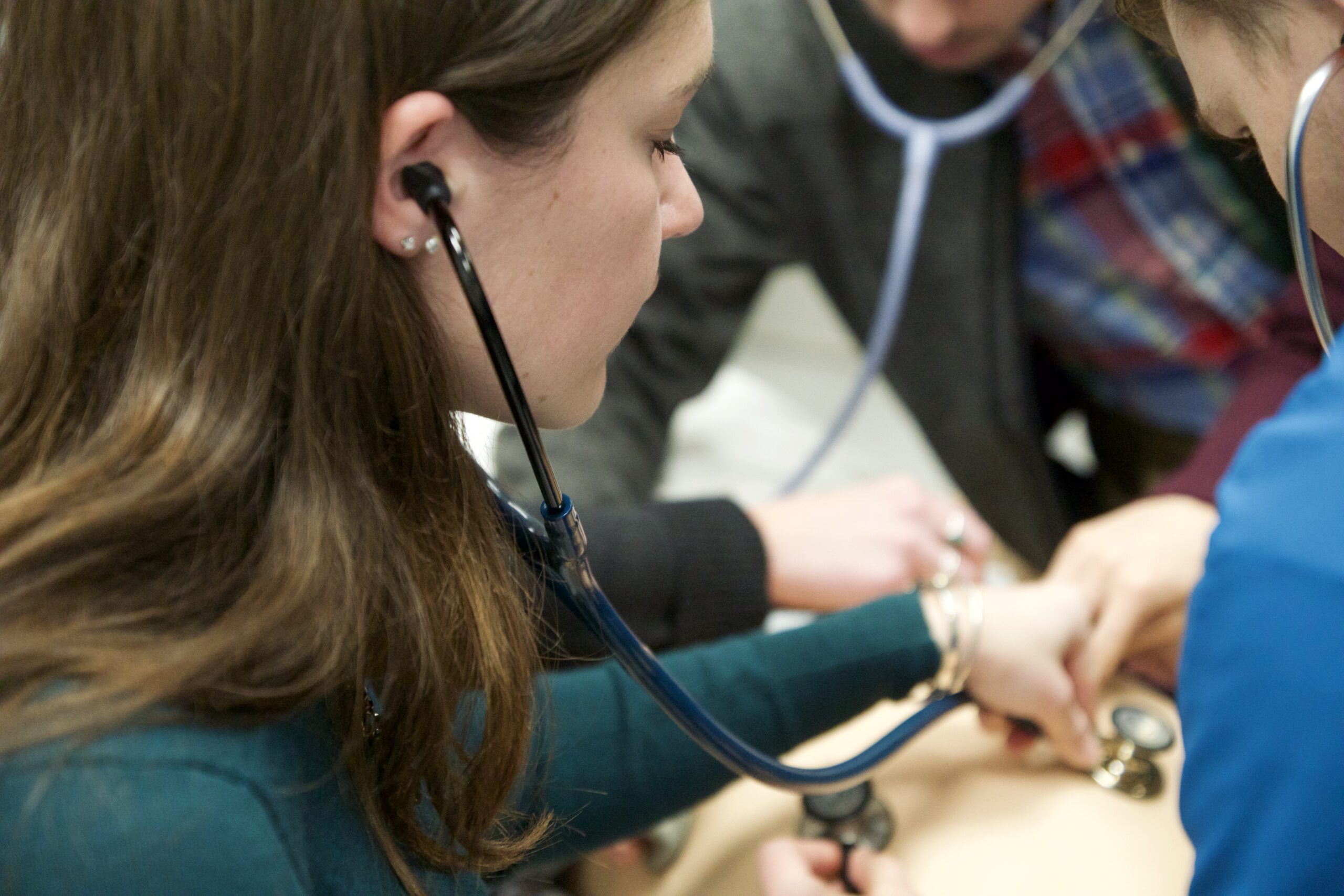 Physician assistant students learning to listen for a heart beat at Northeastern University