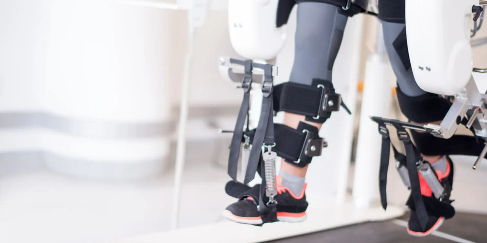 A person's legs are shown with an exoskeleton attached to them.