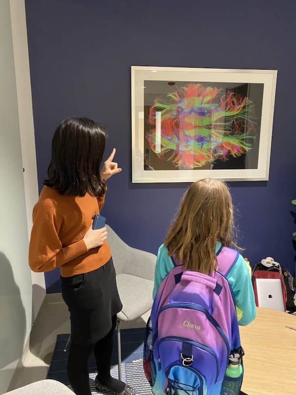 Children staring at a painting on the wall at Northeastern University Biomedical Imaging Center