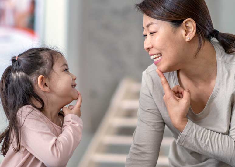 Speech-language pathologist working with little girl