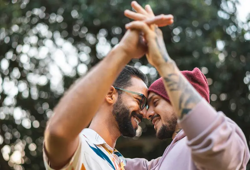 Gay couple dancing and smiling