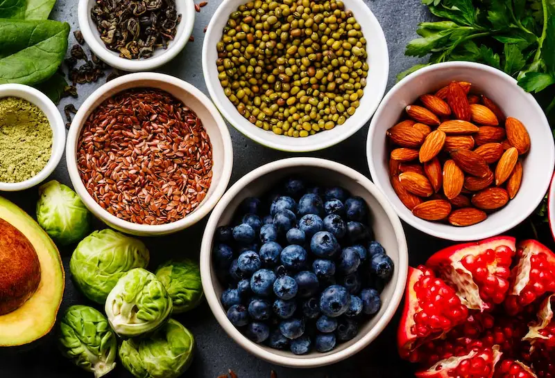 Healthy foods including almonds, blueberries, sprouts, avocado, chia seeds, lentils etc.