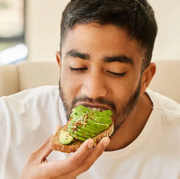 Man enjoying avocado toast.