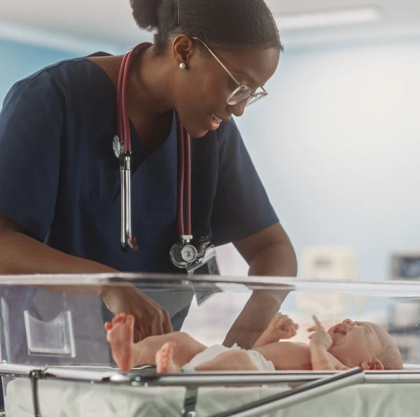 Neonatal nurse of color caring for a vulnerable baby