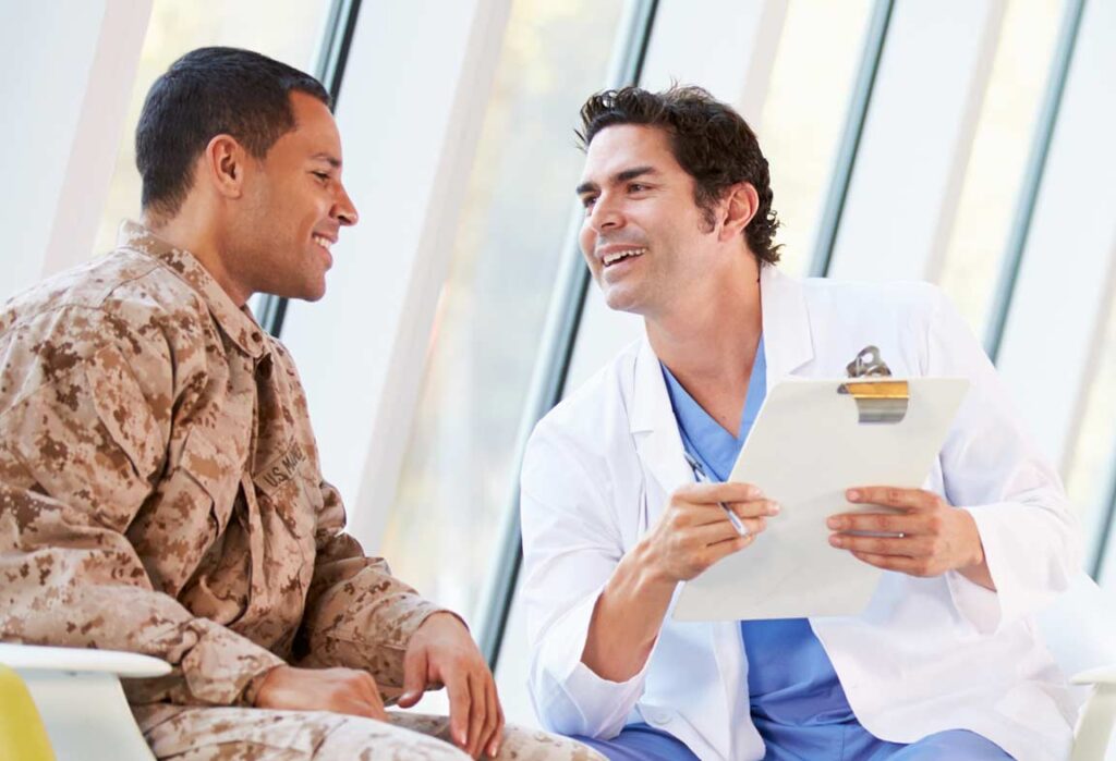 Soldier in uniform speaking with a psychiatric nurse practitioner