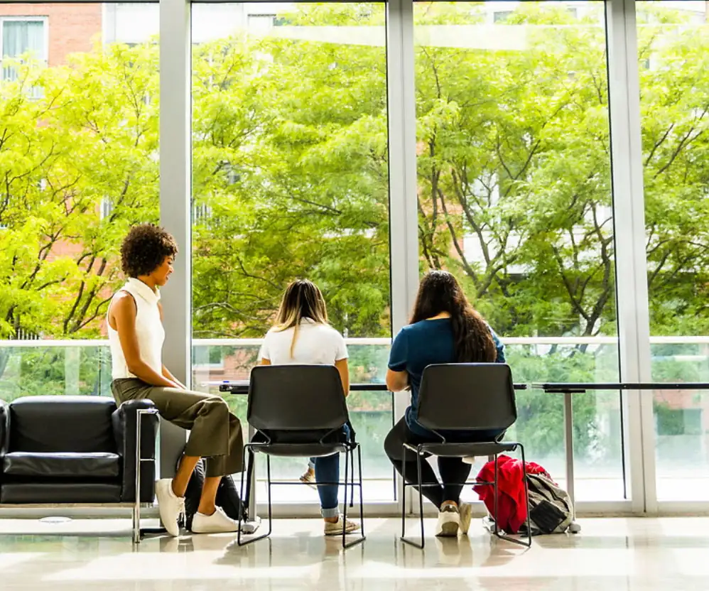Three students studying and talking in one of the many serene spaces on Northeastern's Boston campus
