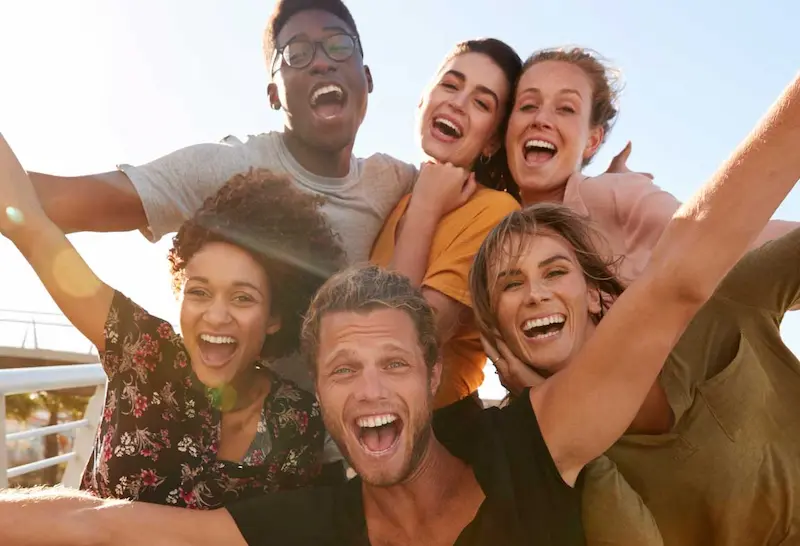 Group of young adults smiling and laughing for the camera