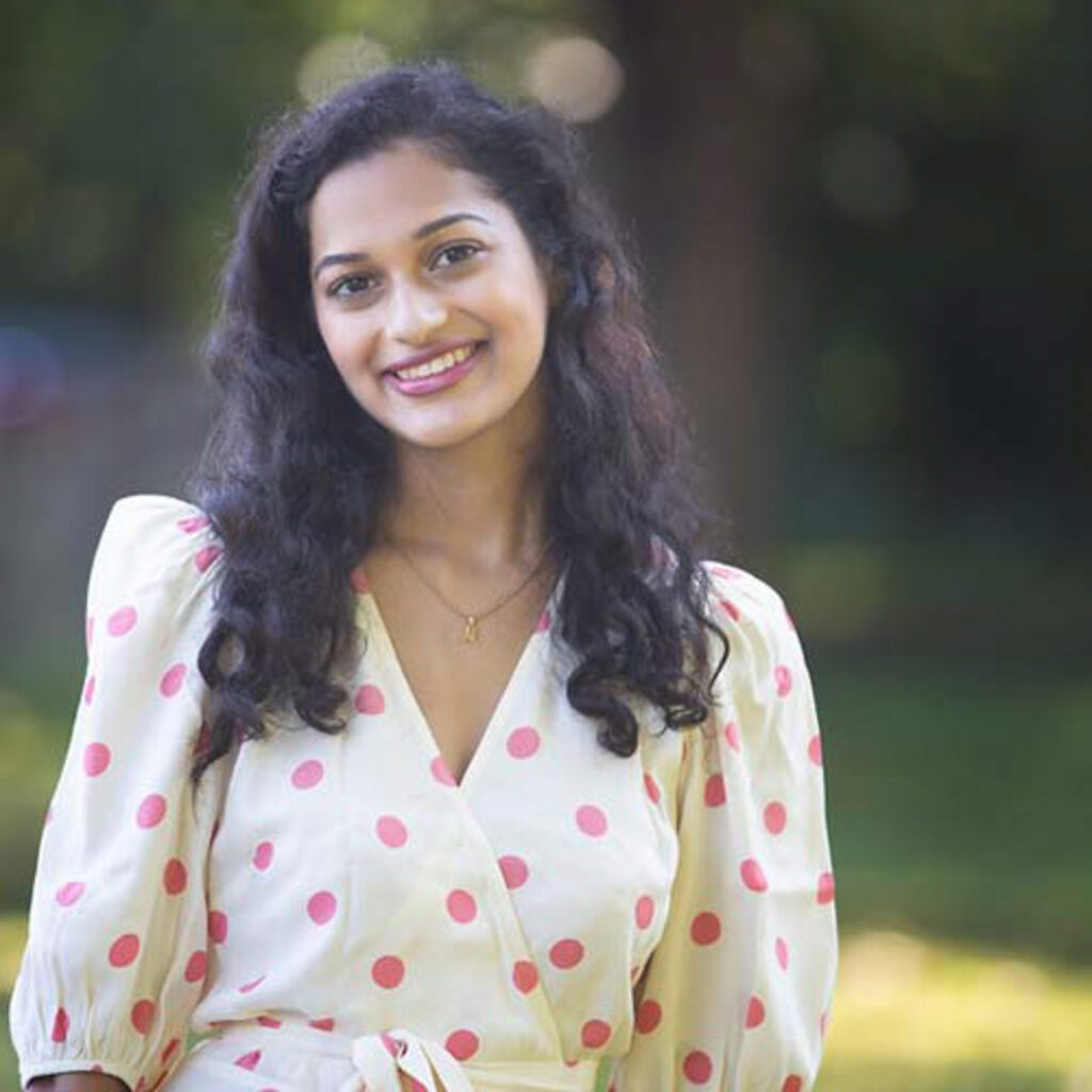 A photo of Meghna Iyer smiling.