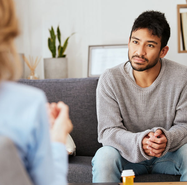 Female therapist speaking with male client