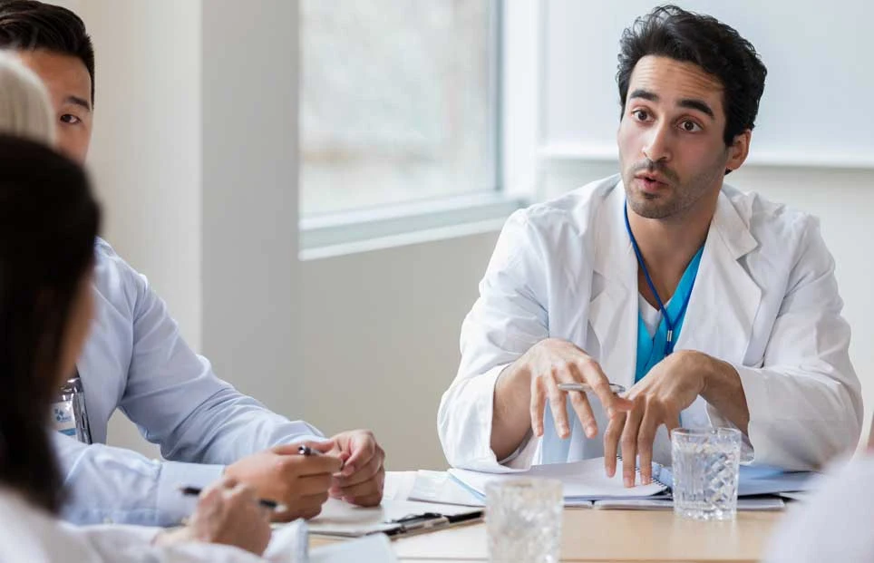 Interdisciplinary medical professionals discussing decisions