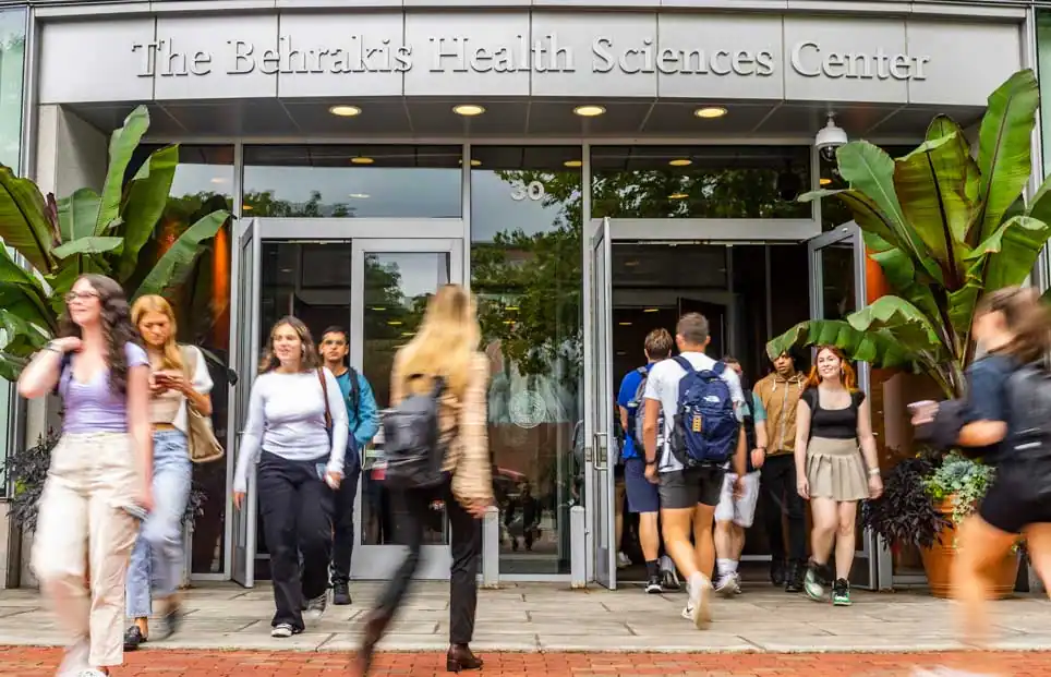 Students walking in and out of the Behrakis Health Sciences Center at Northeastern University