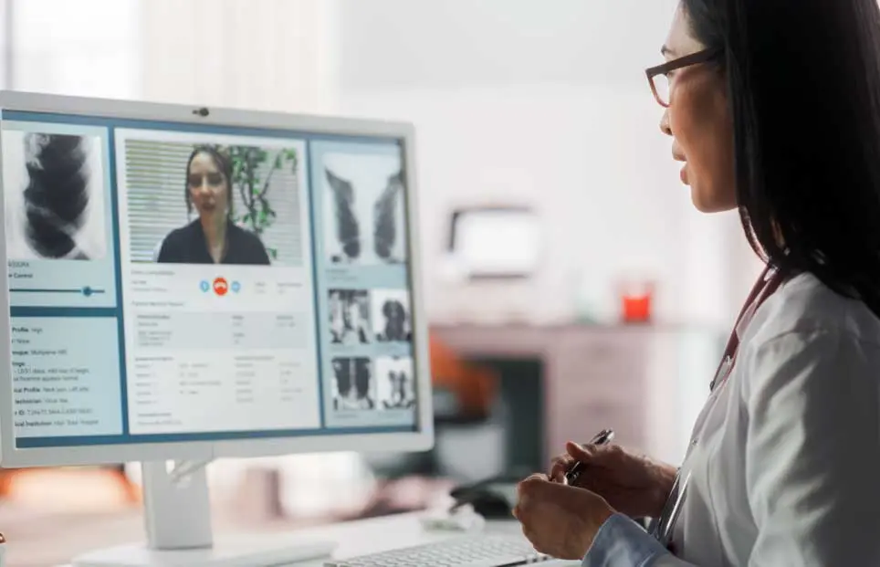 Two clinicians consulting over telehealth