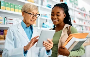 Young woman of color pharmacy student learning the ropes at her first co-op pharmacy experience