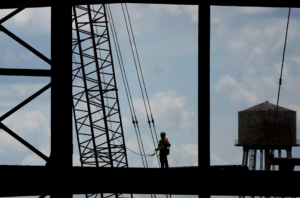 New research from Northeastern on tradeoff between public health and the economy in a pandemic says shutting down construction jobs only marginally reduces infection rates but has a large negative impact on the economy. AP Photo/Charlie Riedel