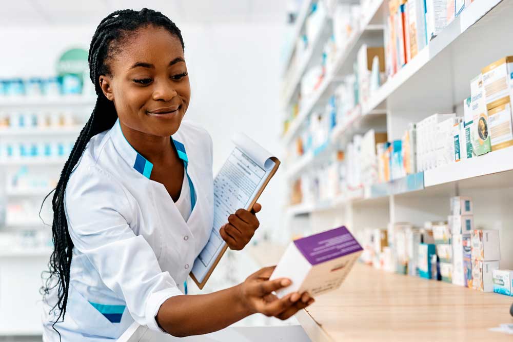 Young pharmacist doing drug inventory at pharmacy