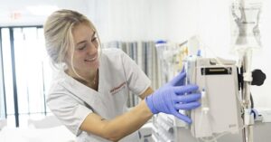 Nursing student in hospital preparing a machine