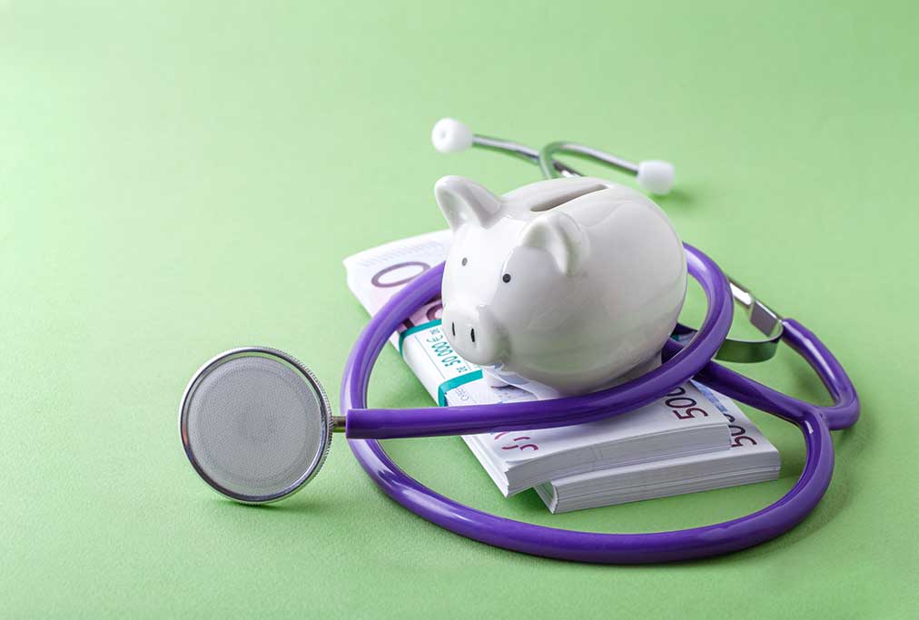 Piggybank on bank notes with a stethoscope