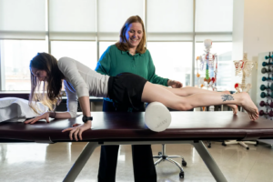 Stretching is one part of a healthy approach to fitness, says Maureen Watkins, shown here working with Northeastern student Abigail Honson. Photo by Alyssa Stone/Northeastern University