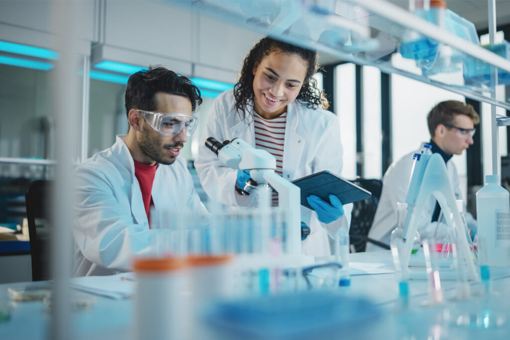 Two public health professionals working in a research laboratory.