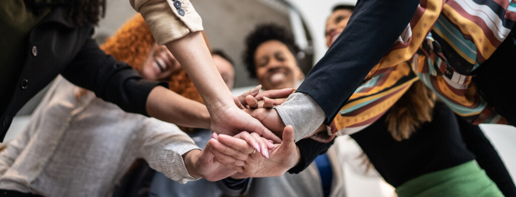 Coworkers with stacked hands at the office