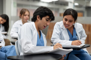 Happy Latin American medical students talking in class and sharing ideas - education concepts