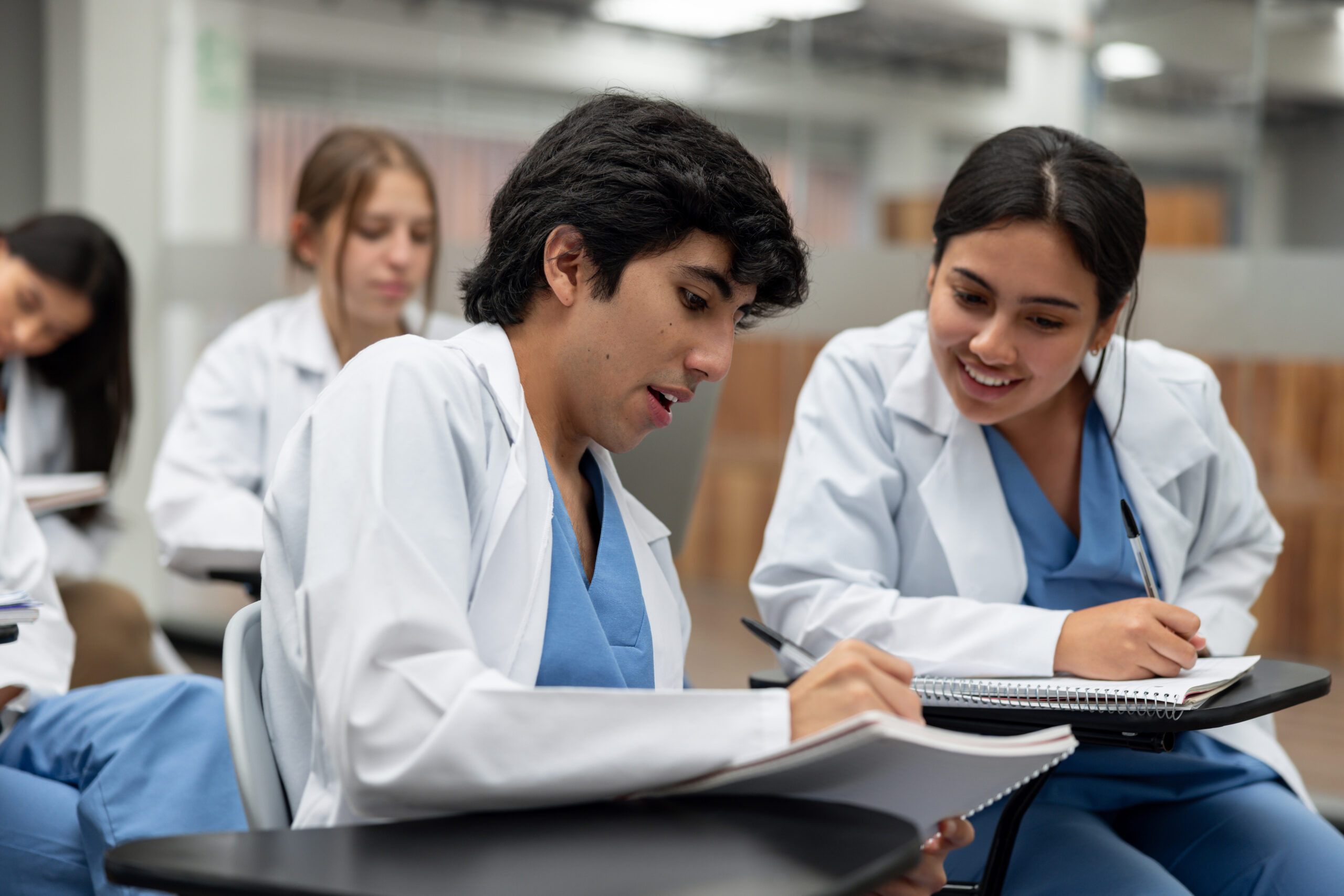Happy Latin American medical students talking in class and sharing ideas - education concepts