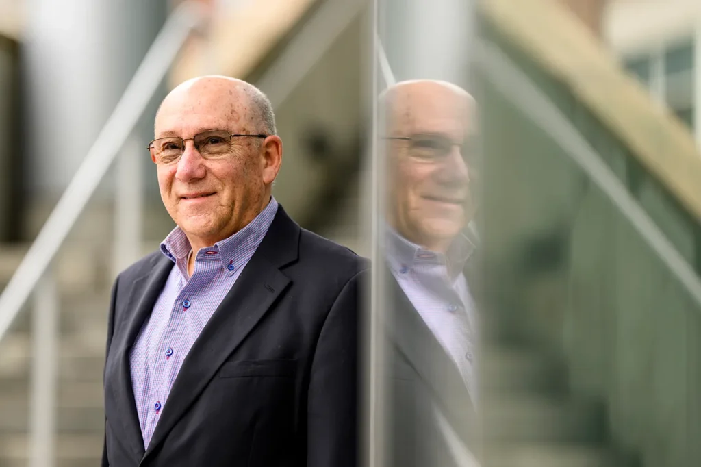 “People joke that I bleed red and black,” says pharmacist Mark Yorra, who is at the center of a long-running family connection to Northeastern. Photo by Matthew Modoono/Northeastern University