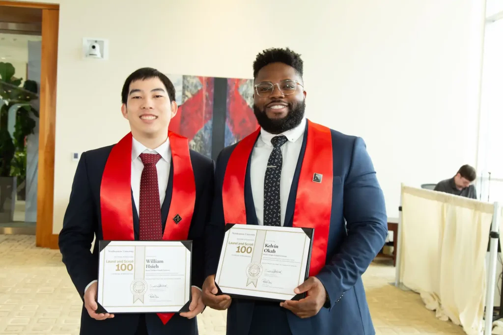Photo of School of Pharmacy and Pharmaceutical Sciences students William Hsieh and Kelvin Okah holding certificates acknowledging their induction into the Laurel and Scroll 100, a society established in 2024 to honor exceptional graduate and professional students across Northeastern’s global university system.