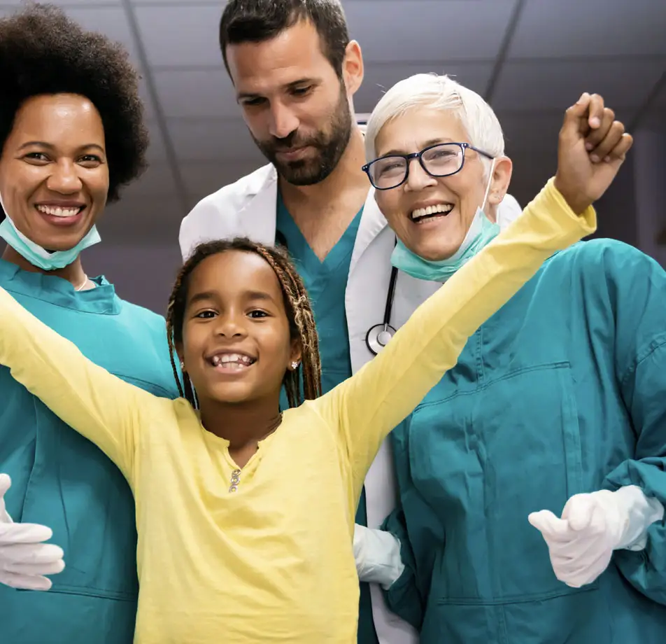 Little girl celebrating with her medical team