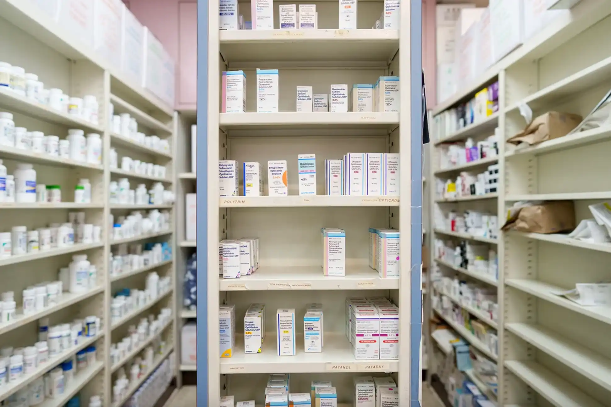 Photo of pharmacy shelves stocked with various drugs