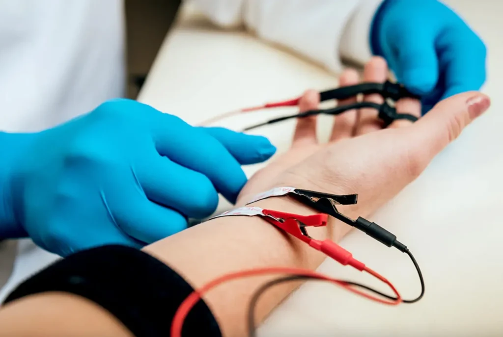 Photo of student receiving shock therapy during a speech-language therapy session.