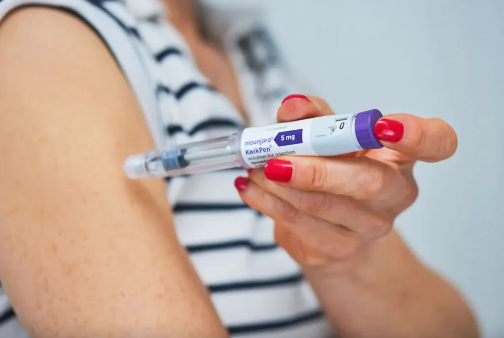 Photo of a person injecting a weight loss drug into their arm.