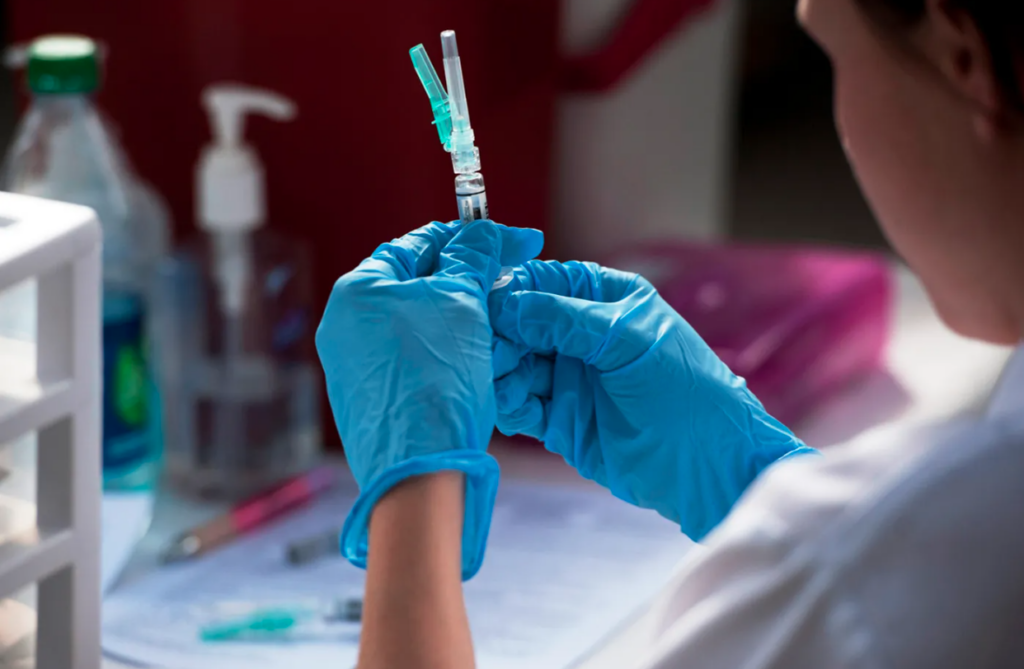 Photo of technician holding a vaccine