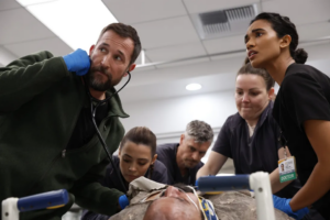 Scene of 5 actors in HBO's show The Pitt caring for a patient