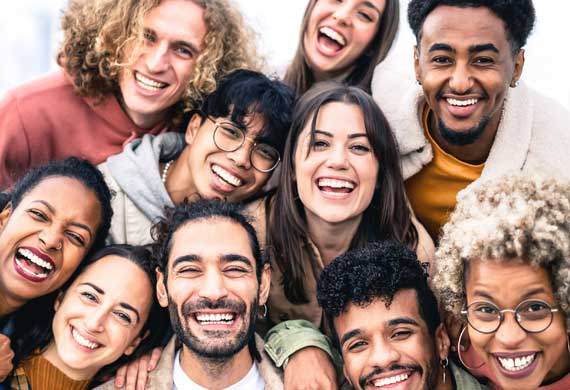 A group of young people smiling together.