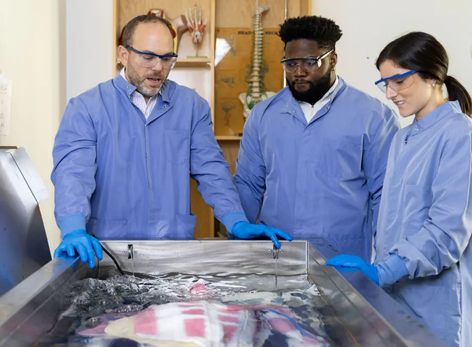 Professor and students in anatomy lab
