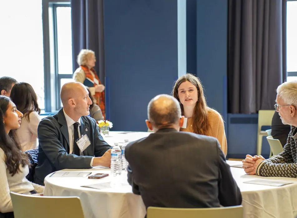 Faculty around a lunch table in deep discussion at the School of Pharmacy and Pharmaceutical Sciences Award Ceremony