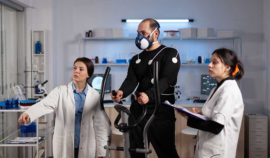 Exercise science researchers reviewing metrics with male subject